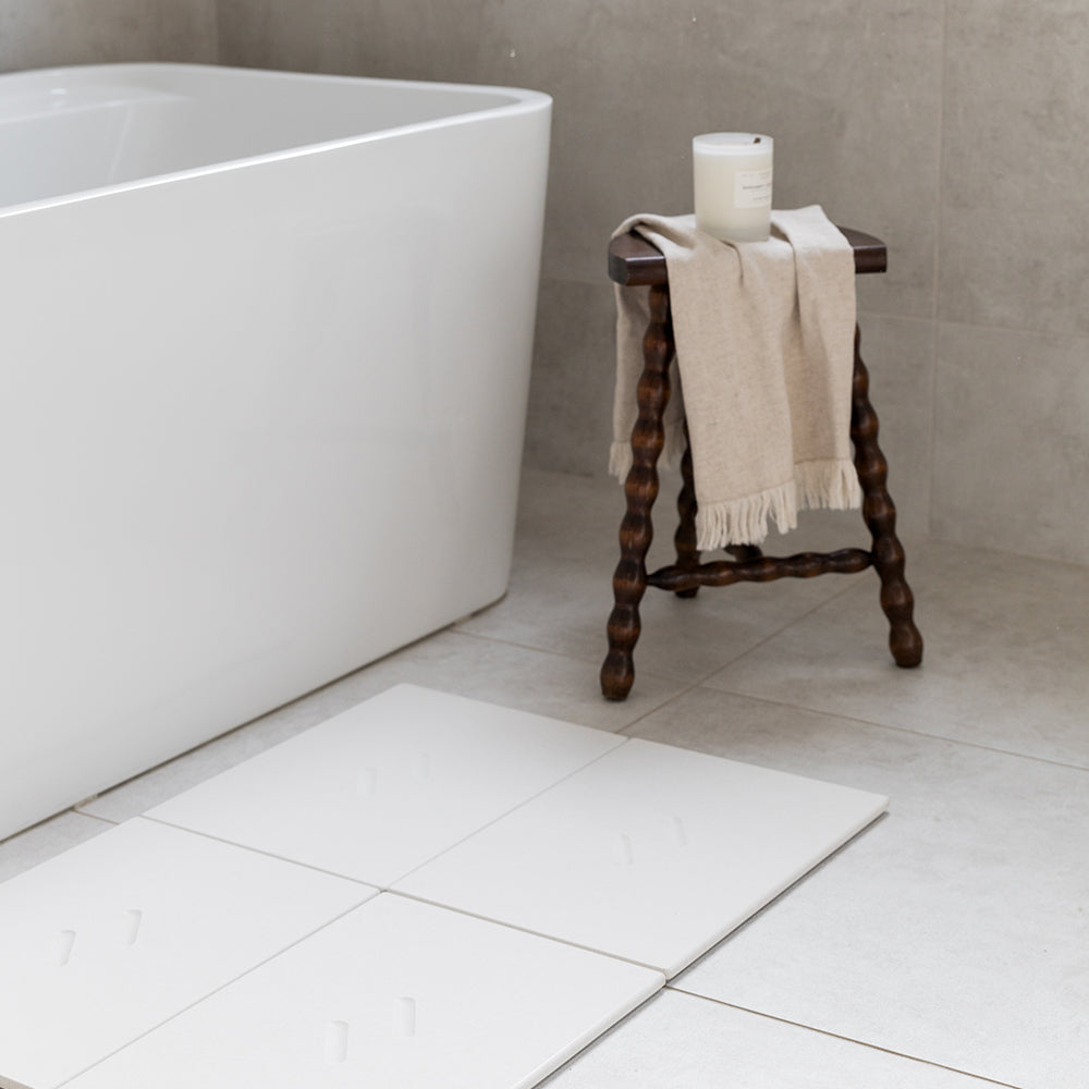 bathroom floor with modern bath mat