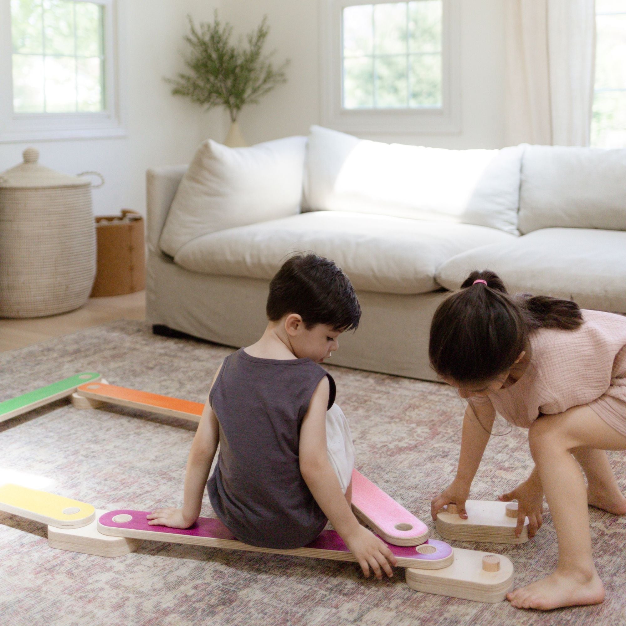 Child enhancing coordination on a balance beam