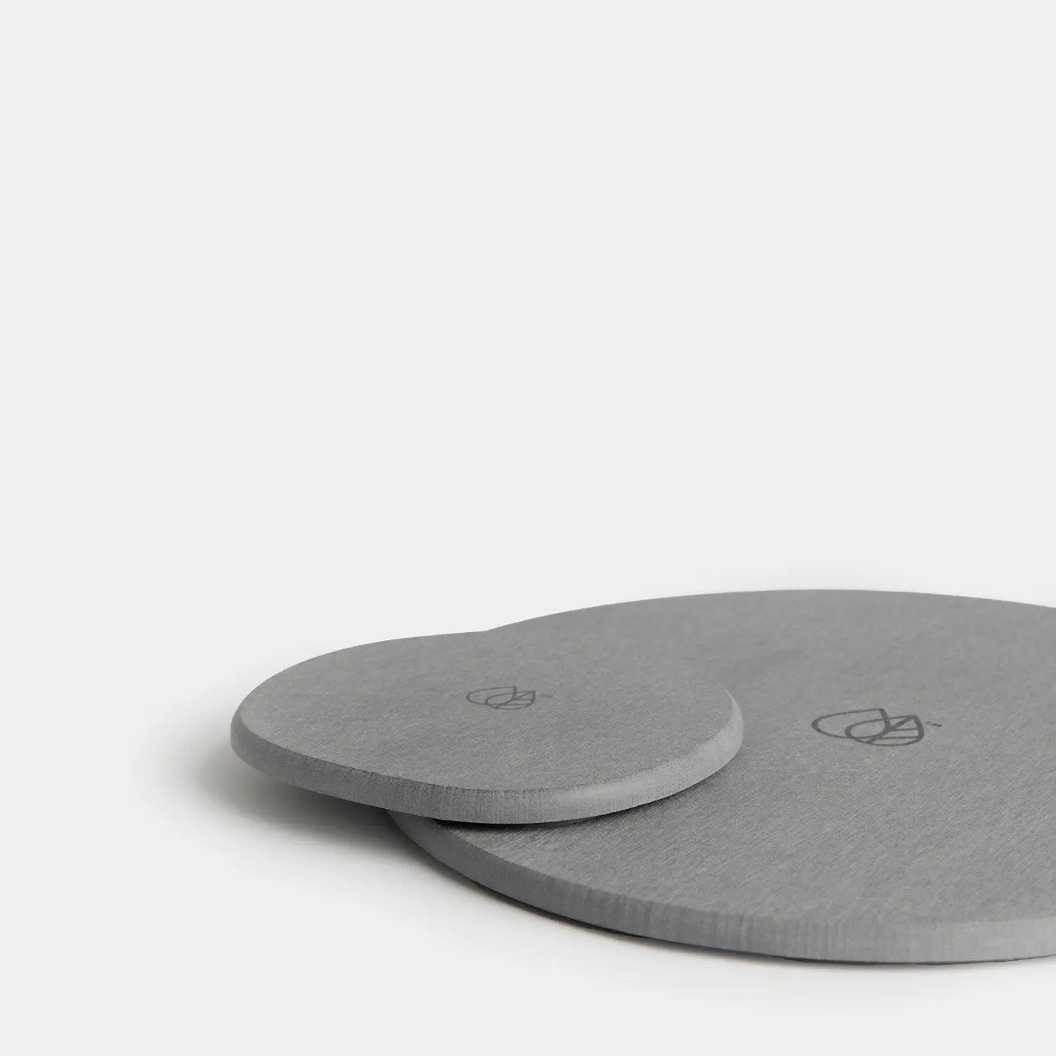 2 sizes of stone trivets in dark grey