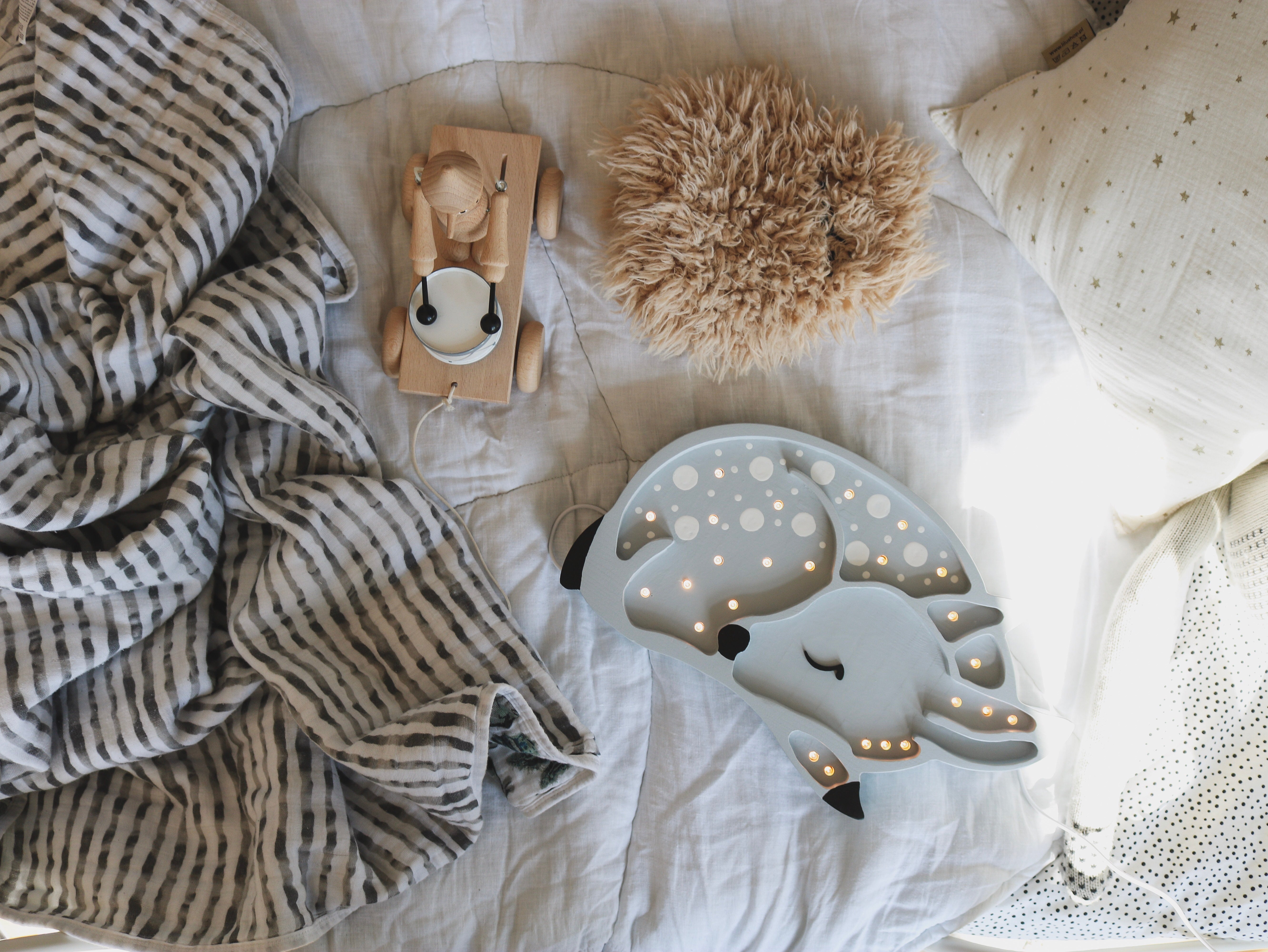 Grey Deer Lamp softly illuminating kids’ room with warm wooden charm