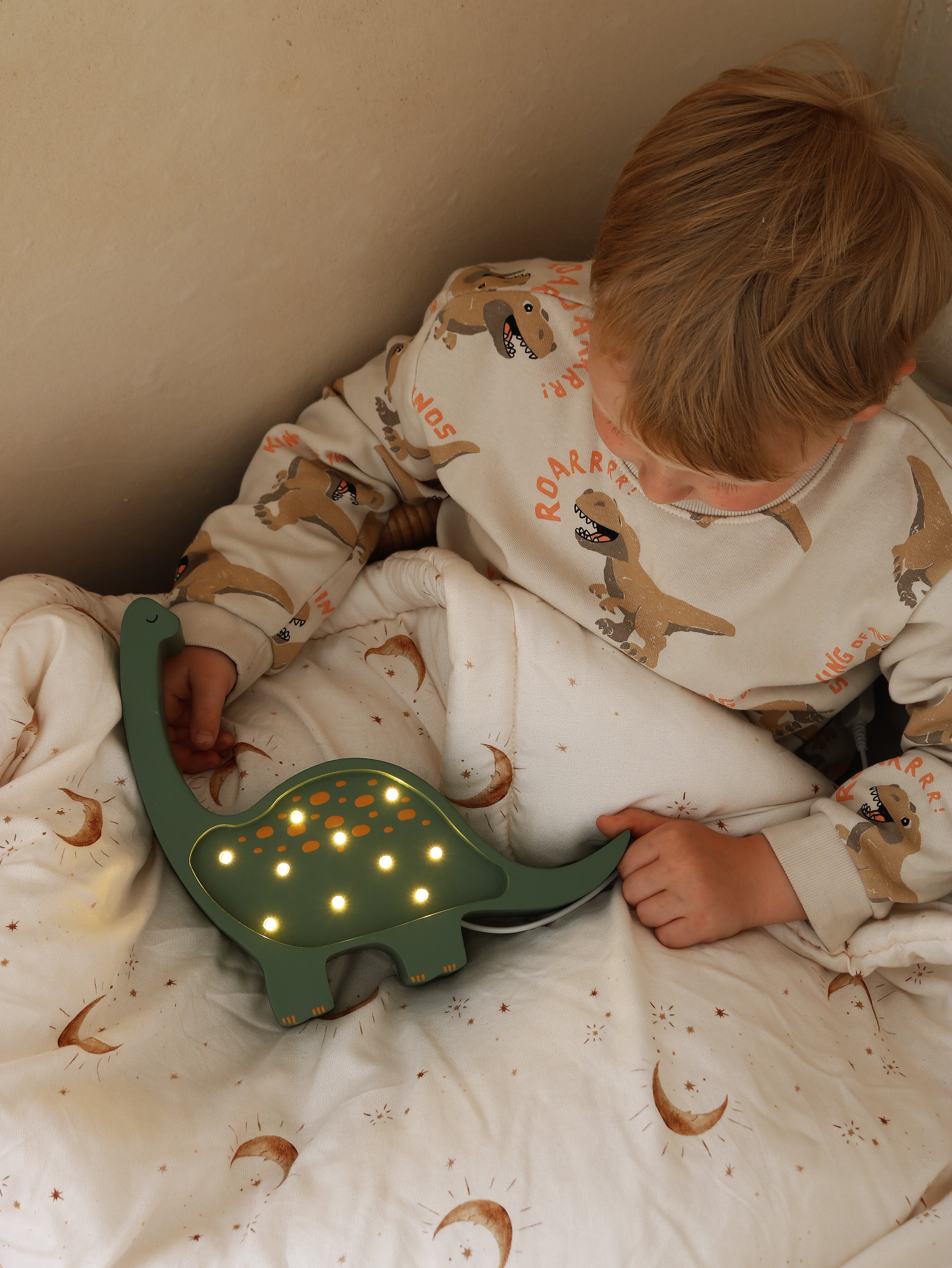 Dimmable wooden dinosaur lamp in military green for kids’ rooms