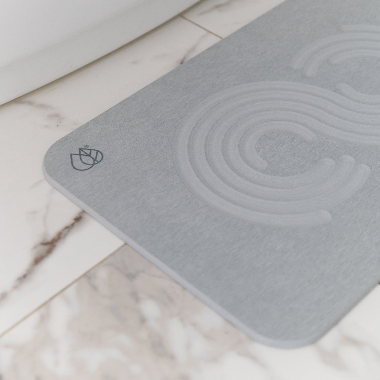 detail of logo on bath stone mat