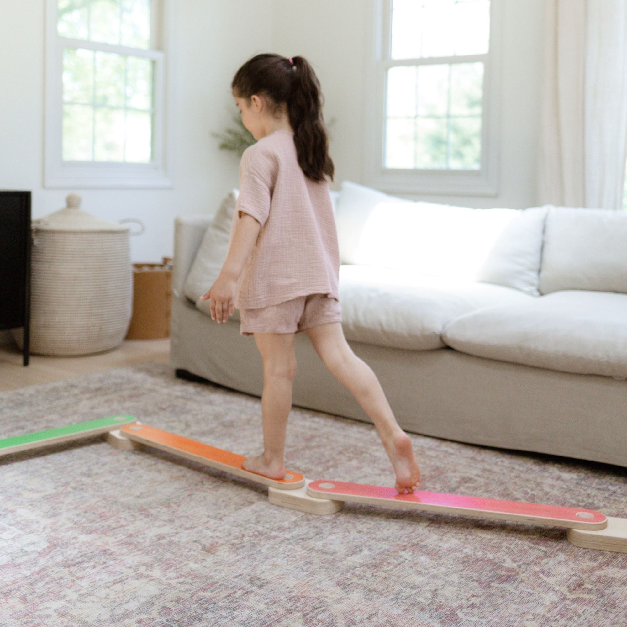 Child stepping carefully on a balance beam