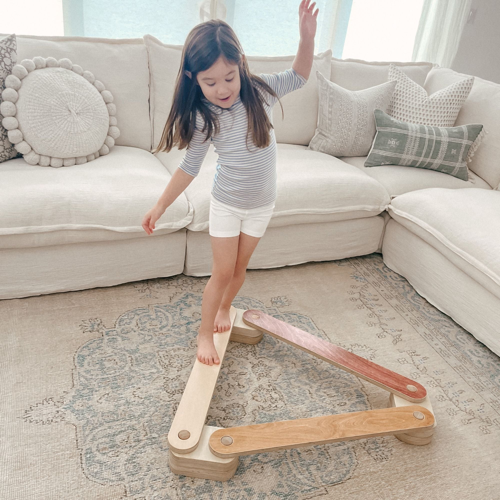 Toddler practicing balance on a beam