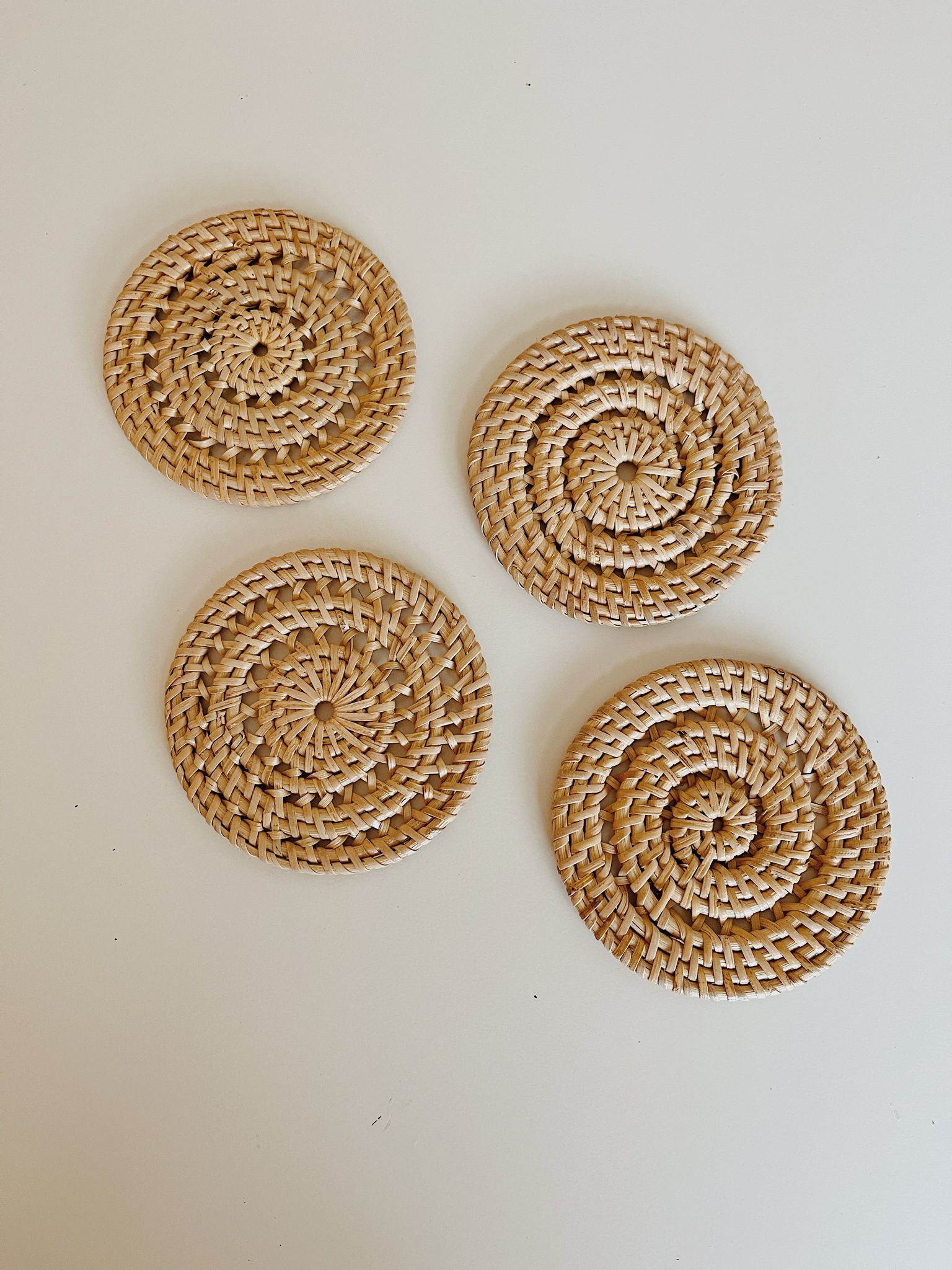 Woven Rattan Coaster Set handmade by Village Thrive using natural materials.